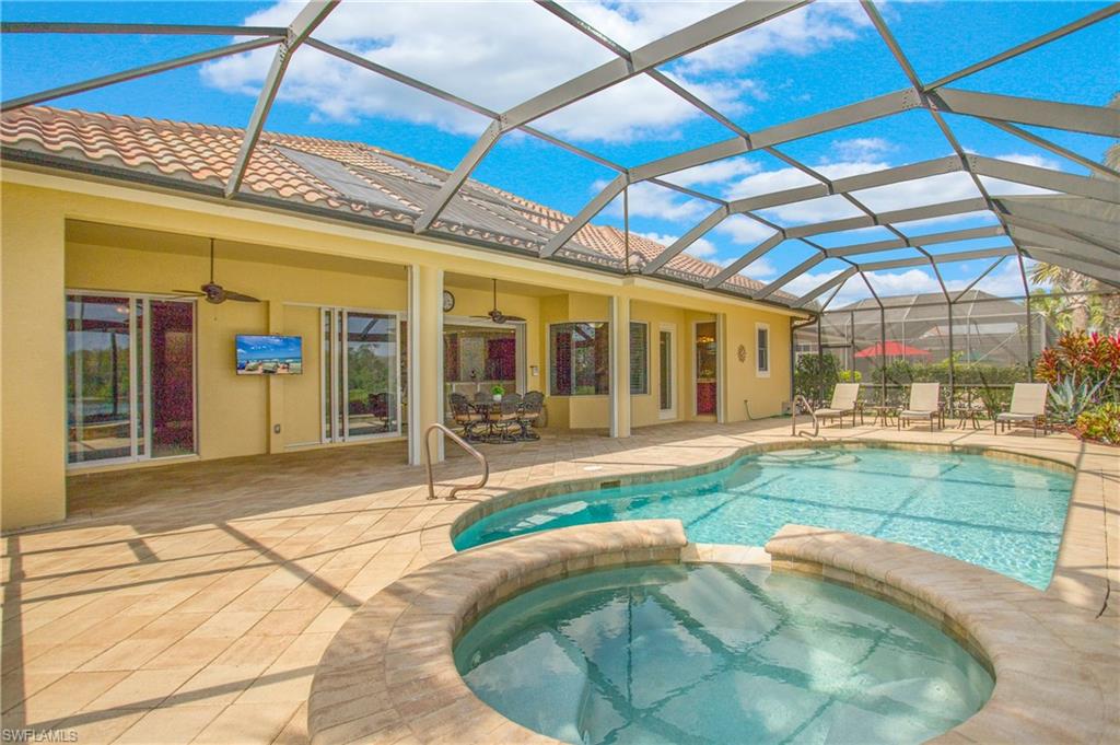 9807 Nickel Ridge Circle Naples, FL 34120 - Photo 43 of 50 a swimming pool with a outdoor seating