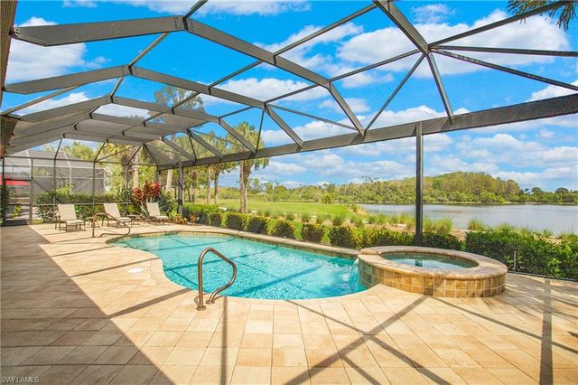a view of a swimming pool with outdoor seating