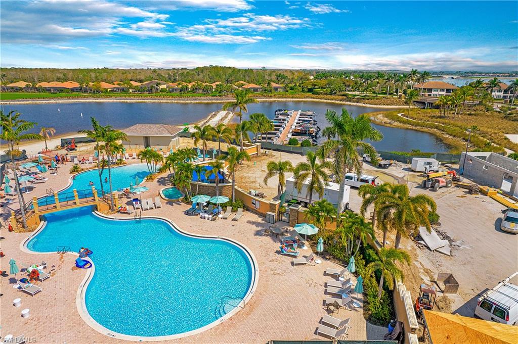 9807 Nickel Ridge Circle Naples, FL 34120 - Photo 47 of 50 a view of a swimming pool with outdoor seating