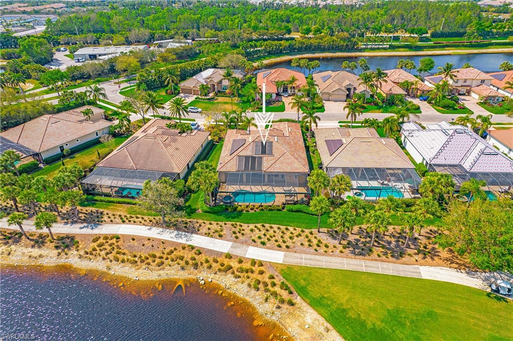 9807 Nickel Ridge Circle Naples, FL 34120 - Photo 5 of 50 an aerial view of a house with a garden and lake view