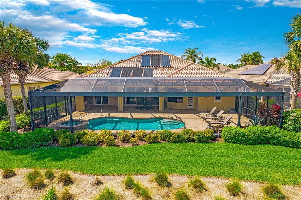 9807 Nickel Ridge Circle Naples, FL 34120 - Photo 6 of 50 a front view of a house with garden