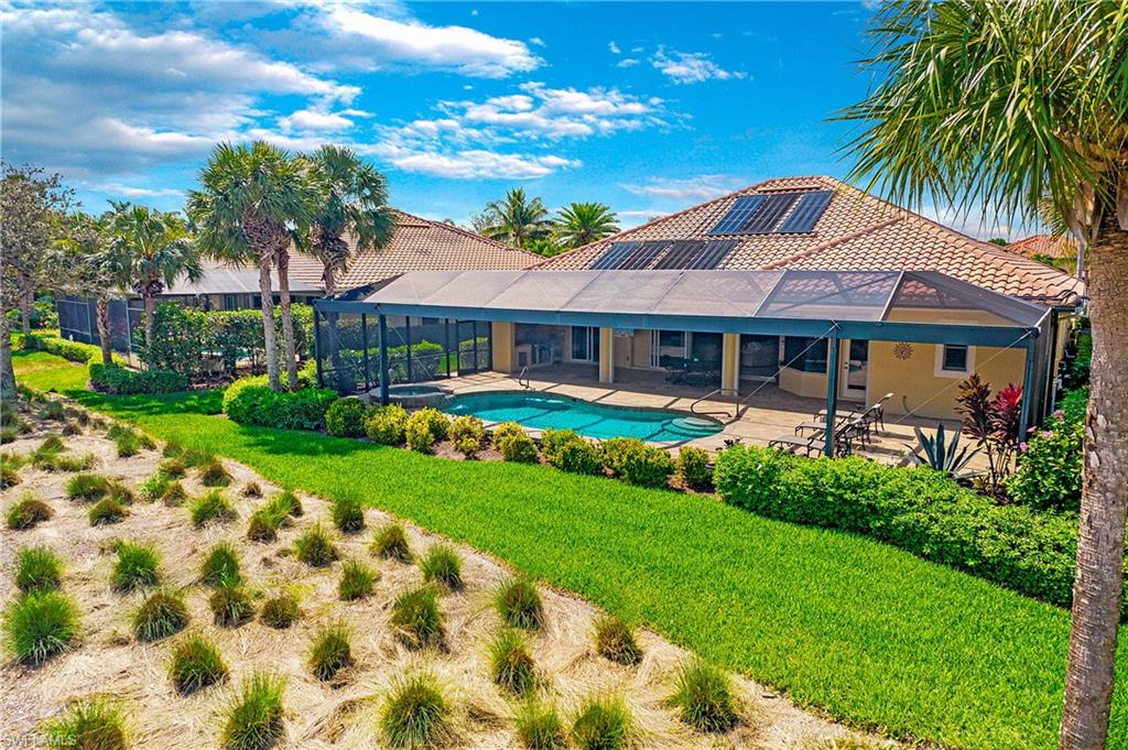 9807 Nickel Ridge Circle Naples, FL 34120 - Photo 7 of 50 a front view of a house with garden