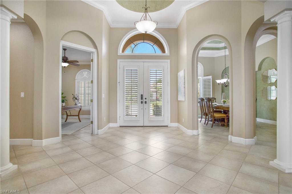 9807 Nickel Ridge Circle Naples, FL 34120 - Photo 9 of 50 a view of a livingroom with a large window and chandelier