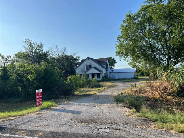 a view of a park with plants and a bench