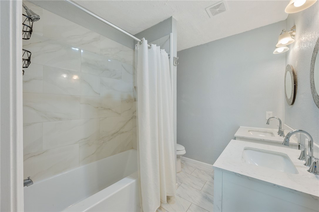 401 East 3rd Street Hearne, TX 77859 - Photo 17 of 25 a bathroom with a sink a toilet and shower