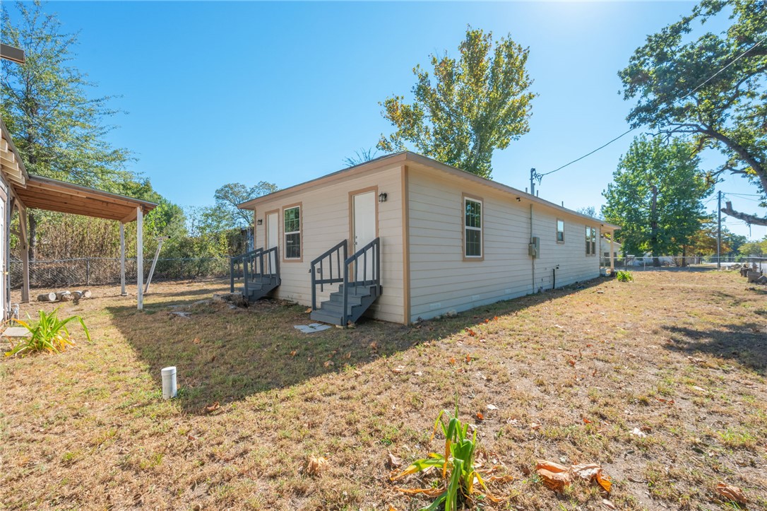 401 East 3rd Street Hearne, TX 77859 - Photo 24 of 25 a view of a house with a yard