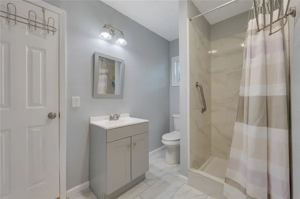 a bathroom with a sink toilet and shower