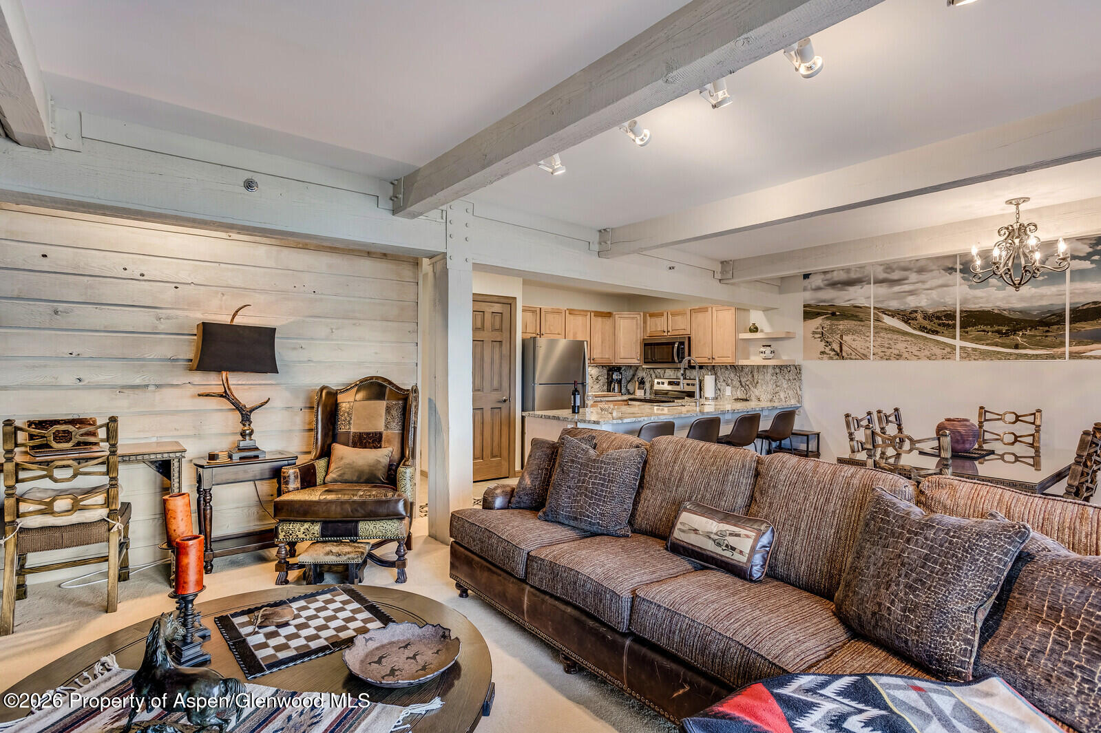 55 Upper Woodbridge Road, Unit E2 Snowmass Village, CO 81615 - Photo 17 of 41 a living room with furniture a rug and a flat screen tv