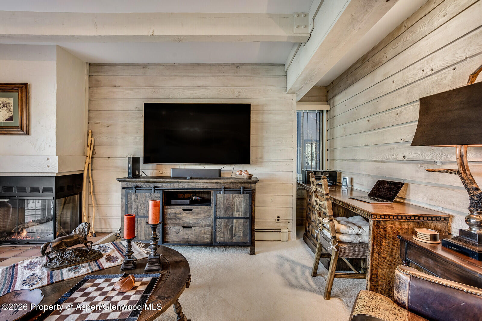 55 Upper Woodbridge Road, Unit E2 Snowmass Village, CO 81615 - Photo 19 of 41 a living room with furniture and a flat screen tv