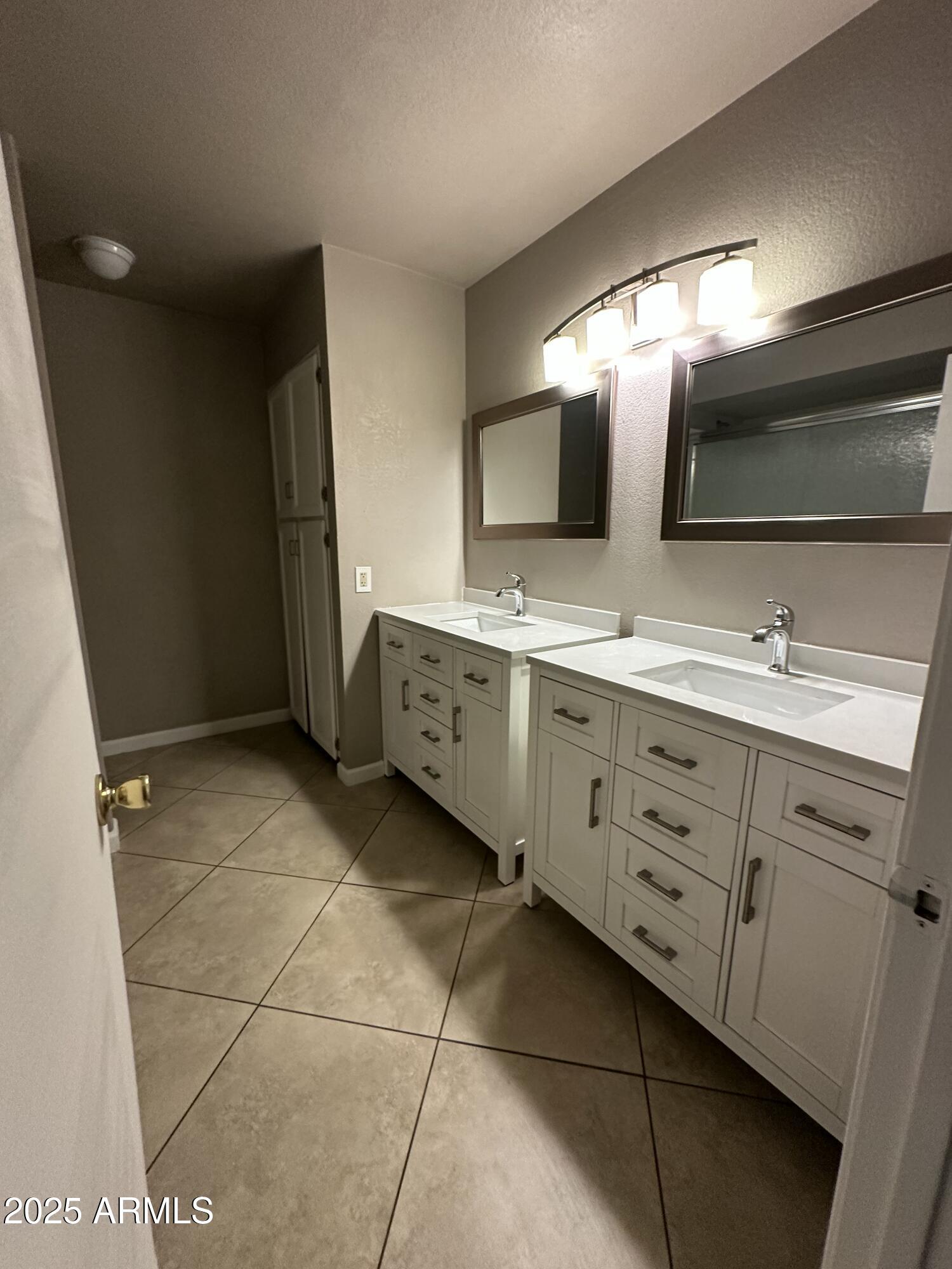 4639 West Ruth Avenue Glendale, AZ 85302 - Photo 11 of 23 a bathroom with a double vanity sink mirror and