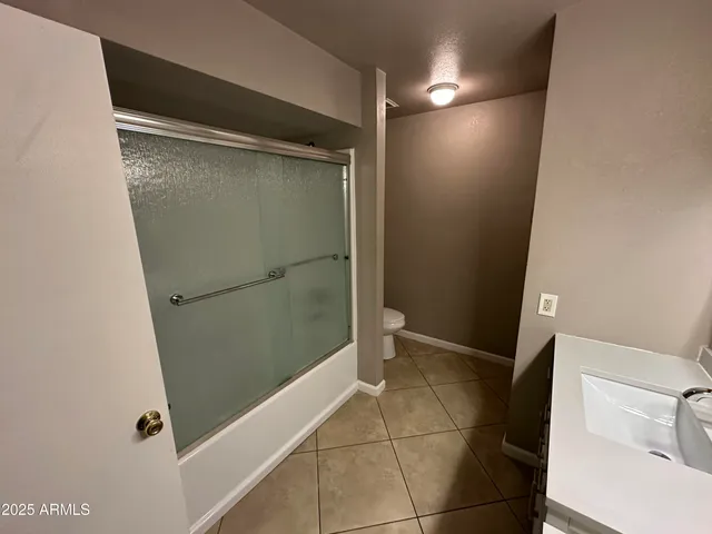 a bathroom with a glass door shower
