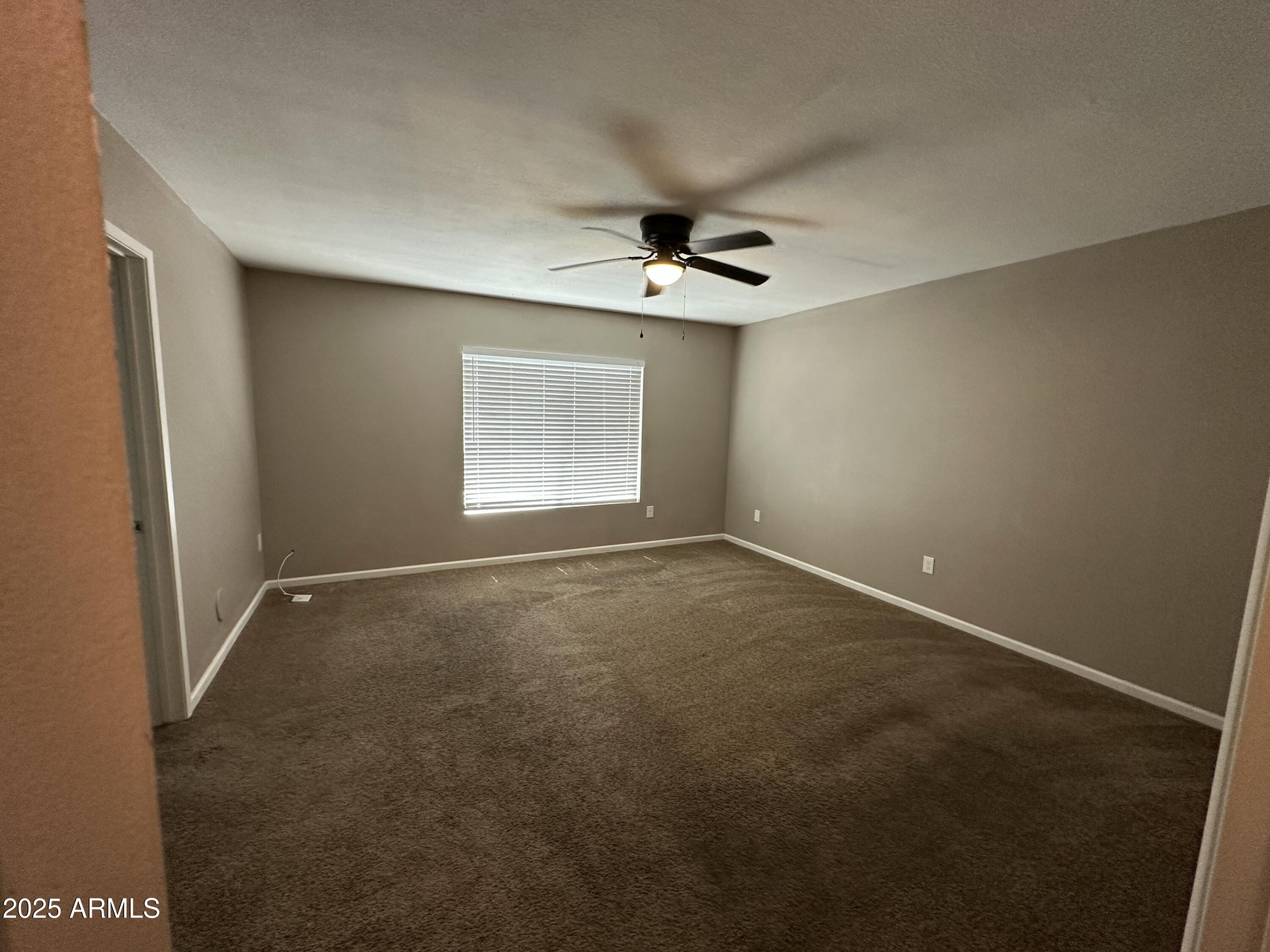 4639 West Ruth Avenue Glendale, AZ 85302 - Photo 13 of 23 an empty room with windows and fan