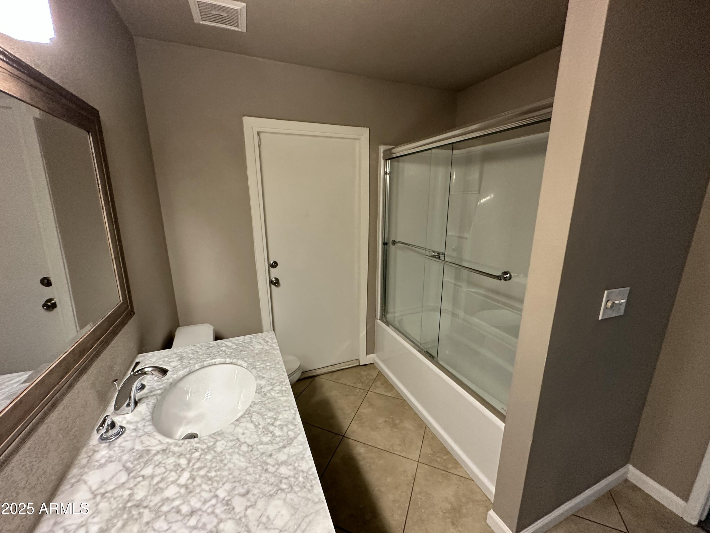 4639 West Ruth Avenue Glendale, AZ 85302 - Photo 16 of 23 a bathroom with a tub and shower