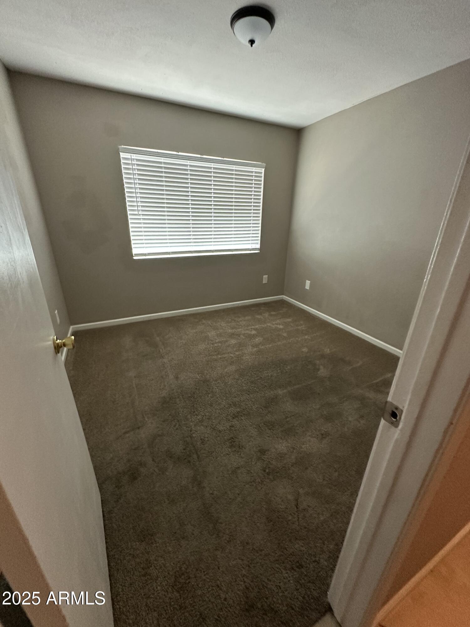 4639 West Ruth Avenue Glendale, AZ 85302 - Photo 17 of 23 a view of an empty room with a window