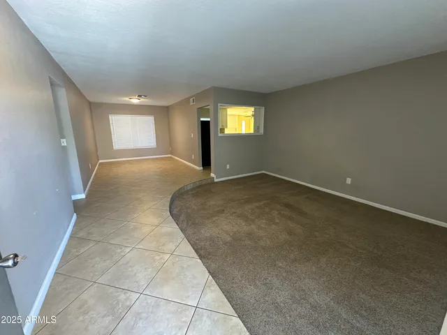an empty room with a window and doors