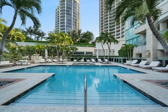 a view of swimming pool with outdoor seating and plants