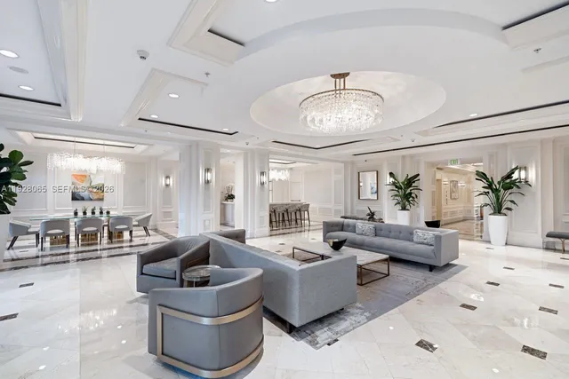 a living room with furniture potted plant and a chandelier