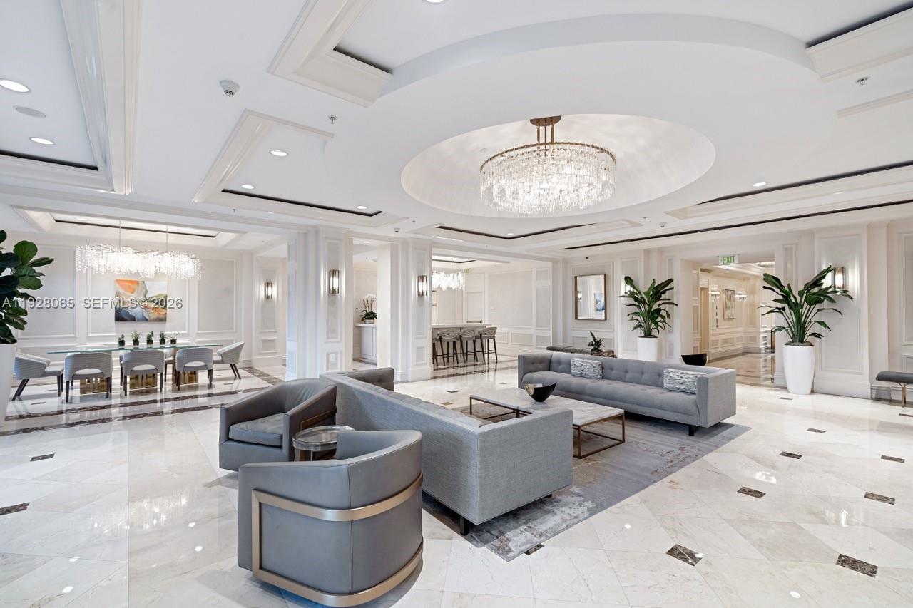 3400 Southwest 27th Avenue, Unit 1805 Miami, FL 33133 - Photo 15 of 28 a living room with furniture potted plant and a chandelier