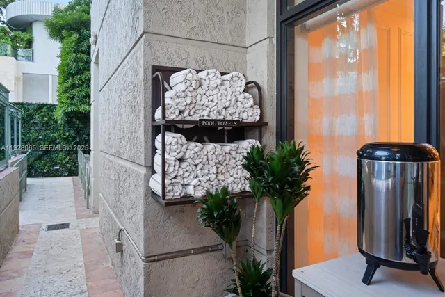 a vase with flowers sitting on a table in front of a window