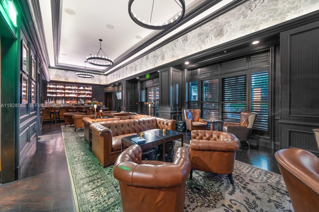 3400 Southwest 27th Avenue, Unit 1805 Miami, FL 33133 - Photo 20 of 28 a living room with furniture a rug and a floor to ceiling window