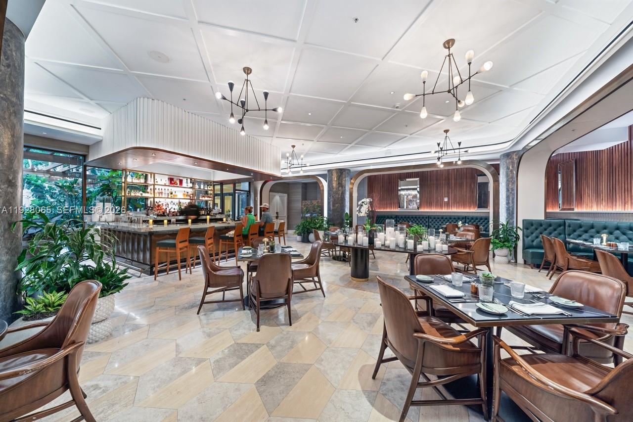 3400 Southwest 27th Avenue, Unit 1805 Miami, FL 33133 - Photo 21 of 28 a view of a dining room with furniture window and outdoor view