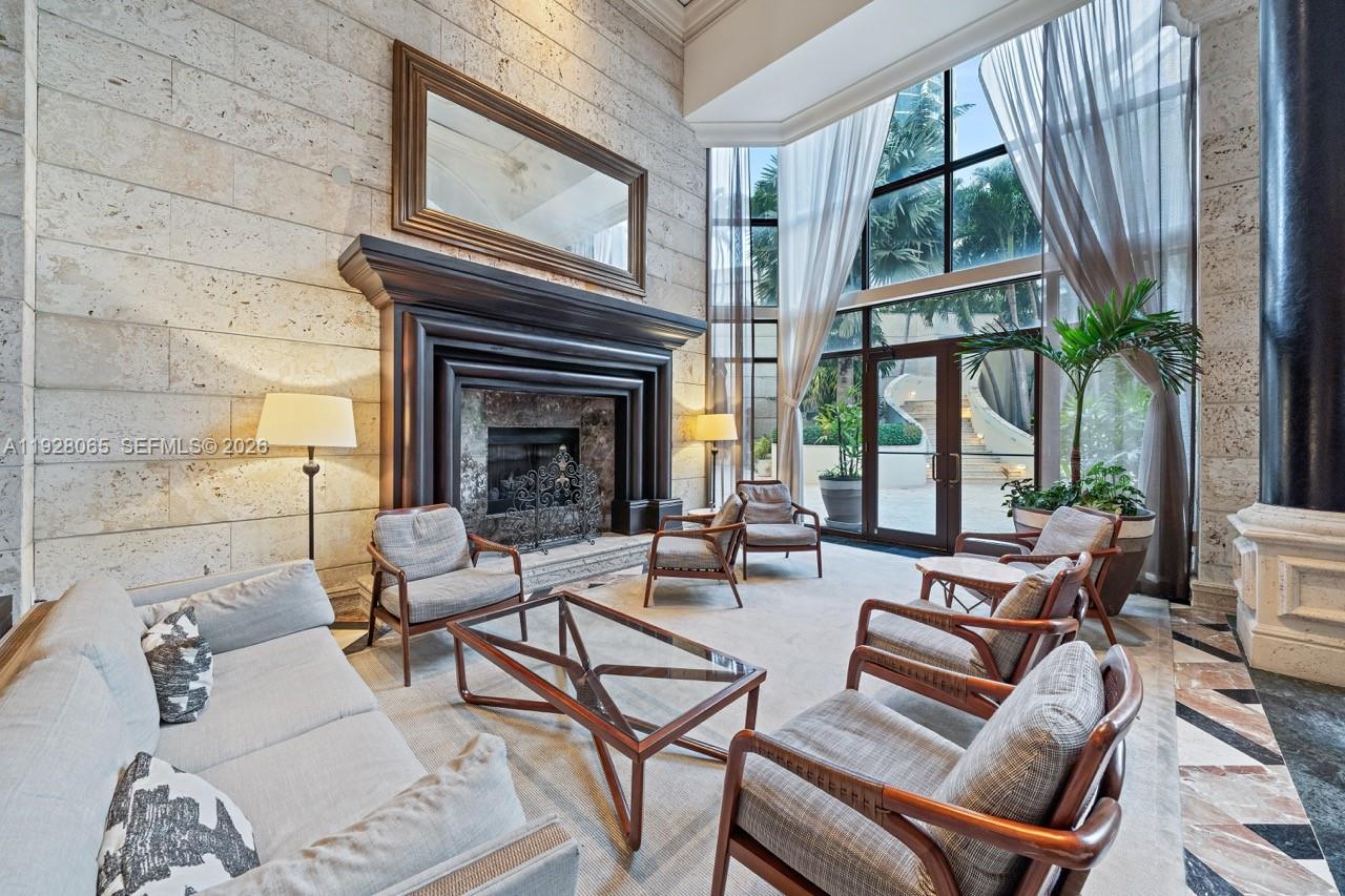 3400 Southwest 27th Avenue, Unit 1805 Miami, FL 33133 - Photo 22 of 28 a living room with furniture a large window and a fireplace