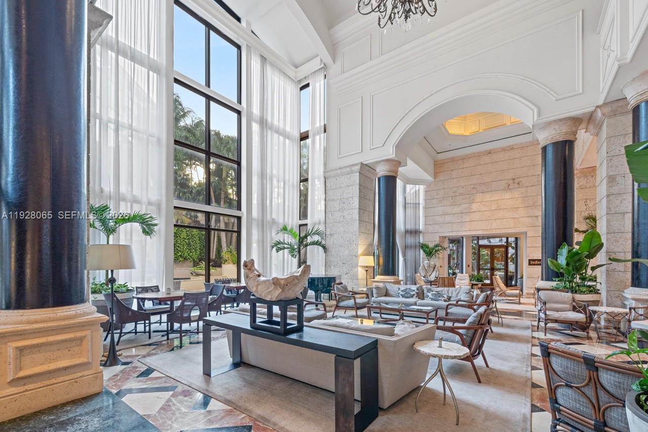 3400 Southwest 27th Avenue, Unit 1805 Miami, FL 33133 - Photo 23 of 28 a living room with fireplace furniture and a large window