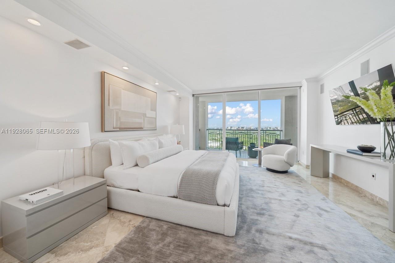 3400 Southwest 27th Avenue, Unit 1805 Miami, FL 33133 - Photo 6 of 28 a spacious bedroom with a bed and a large window