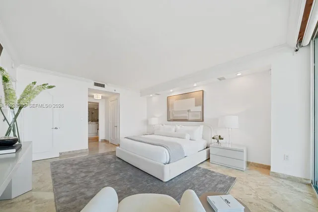 a bedroom with a bed couch and a potted plant