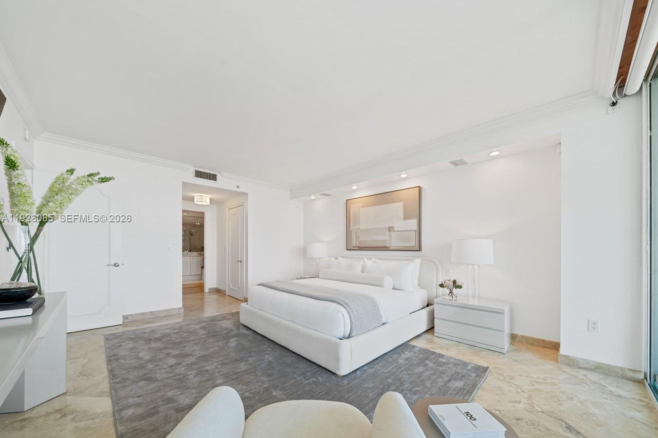 3400 Southwest 27th Avenue, Unit 1805 Miami, FL 33133 - Photo 7 of 28 a bedroom with a bed couch and a potted plant