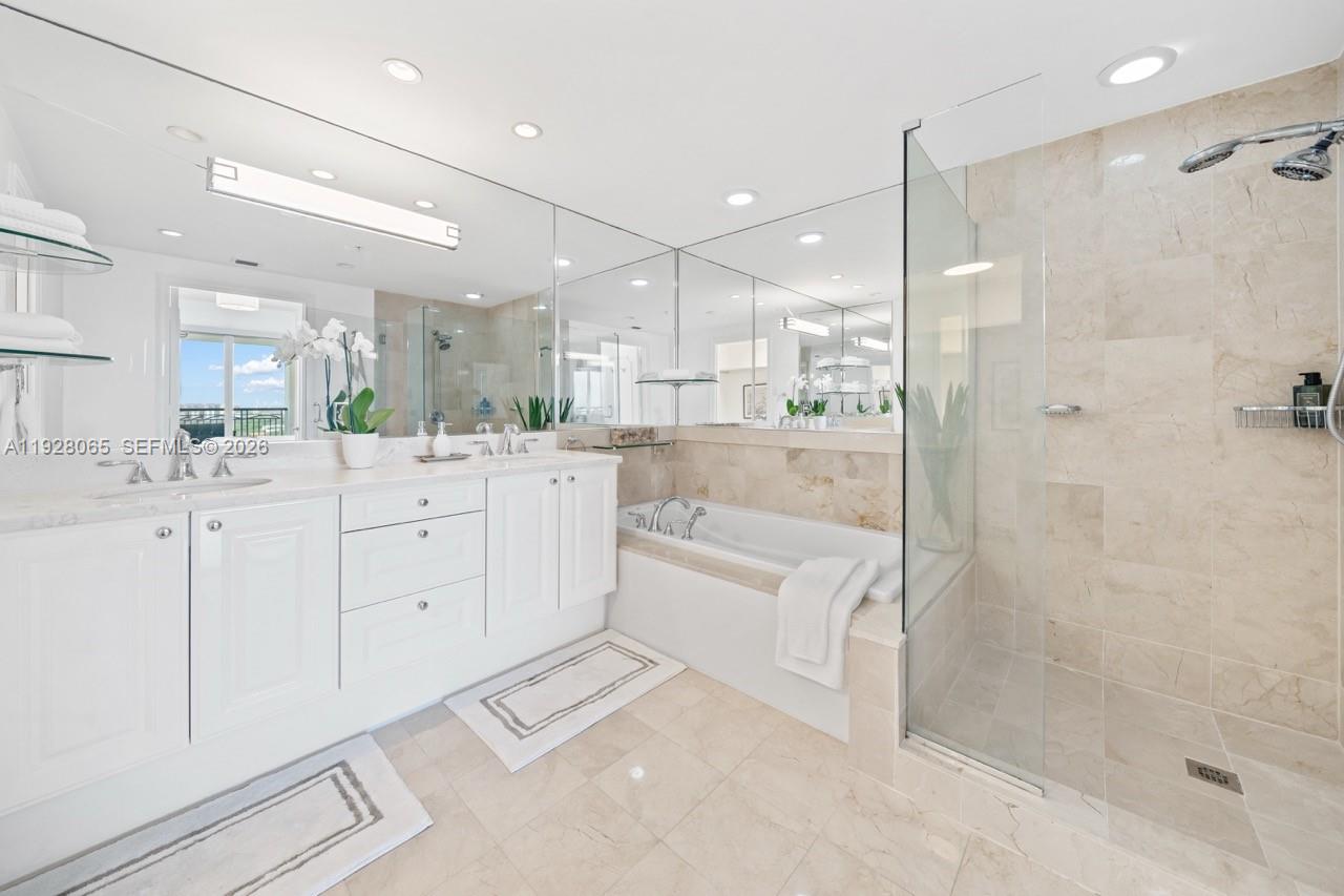 3400 Southwest 27th Avenue, Unit 1805 Miami, FL 33133 - Photo 8 of 28 a large bathroom with a glass shower door