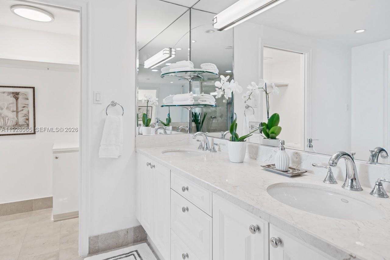 3400 Southwest 27th Avenue, Unit 1805 Miami, FL 33133 - Photo 9 of 28 a bathroom with double vanity sink and a mirror