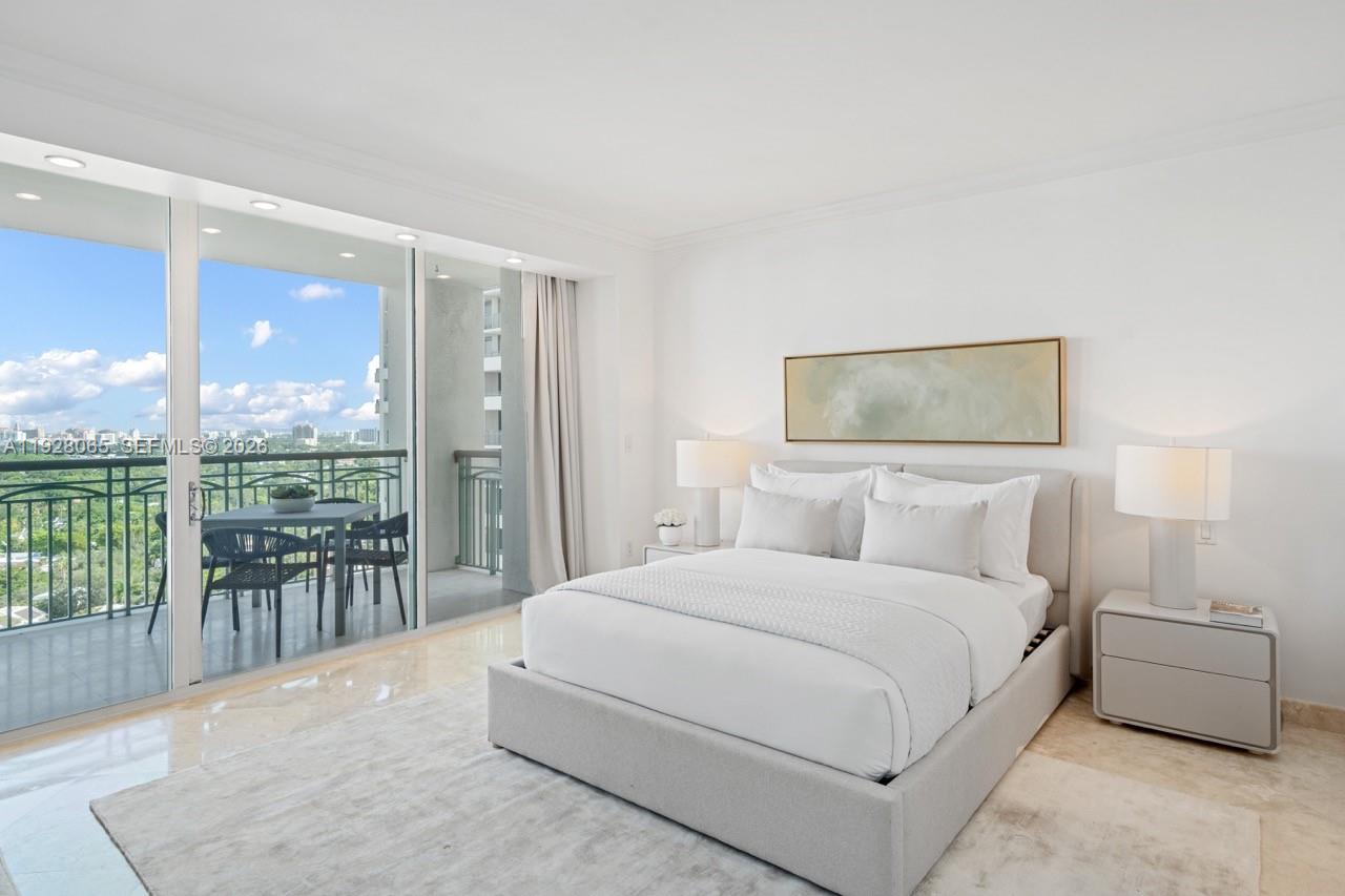 3400 Southwest 27th Avenue, Unit 1805 Miami, FL 33133 - Photo 10 of 28 a bedroom with a large bed and a large window