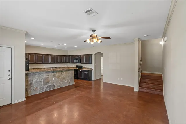 a view of kitchen with cabinets and refrigerator