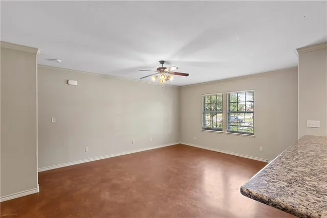 a view of a livingroom with a ceiling fan and window