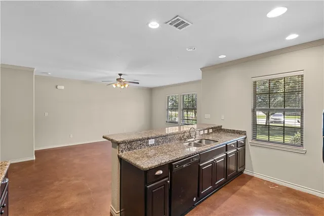 a kitchen with a stove a sink a refrigerator and window