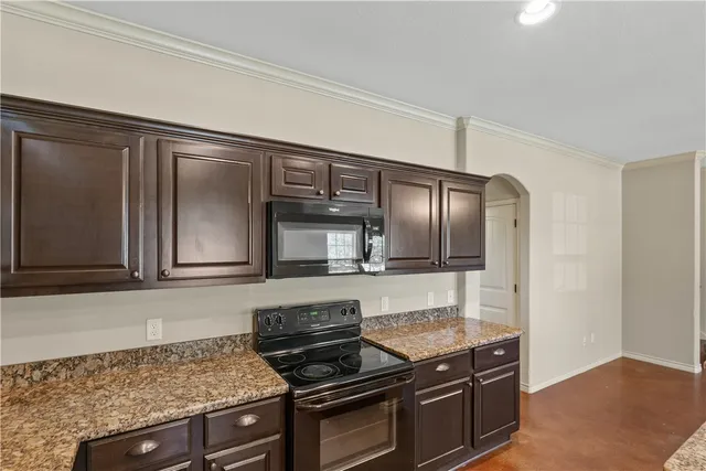 a kitchen with granite countertop stainless steel appliances and cabinets