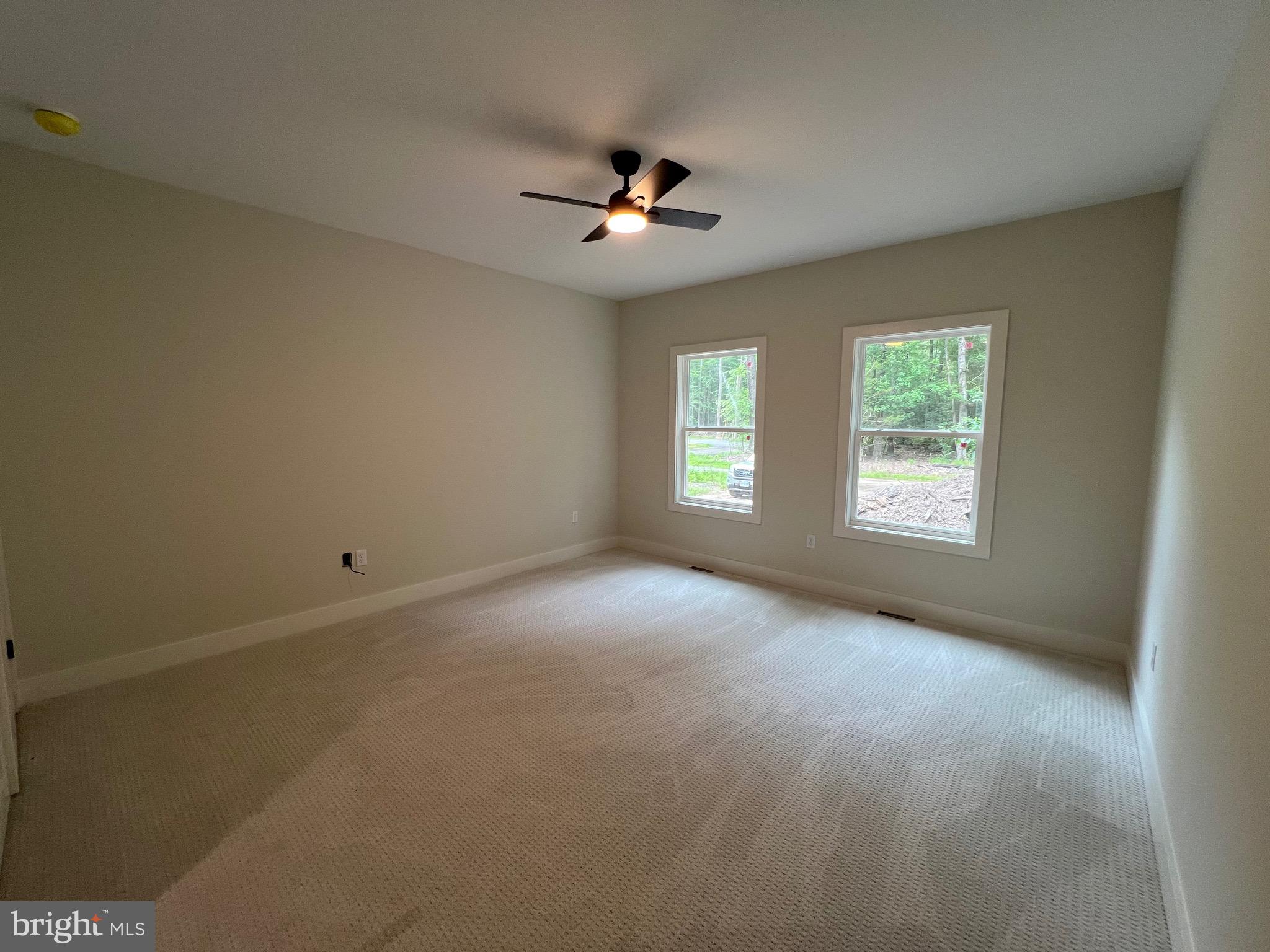175 Rose Way Colonial Beach, VA 22443 - Photo 16 of 33 an empty room with windows and ceiling fan