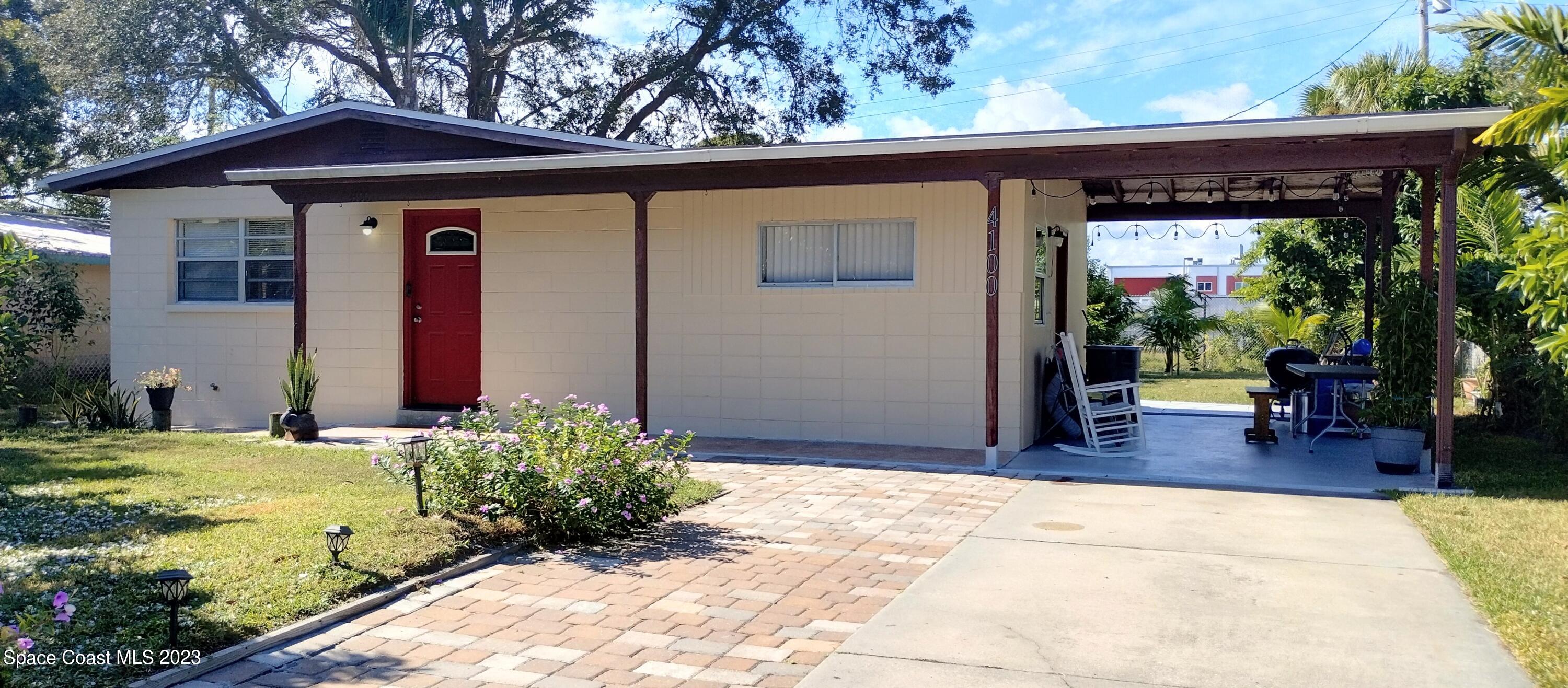 a view of backyard with large trees and a small yard