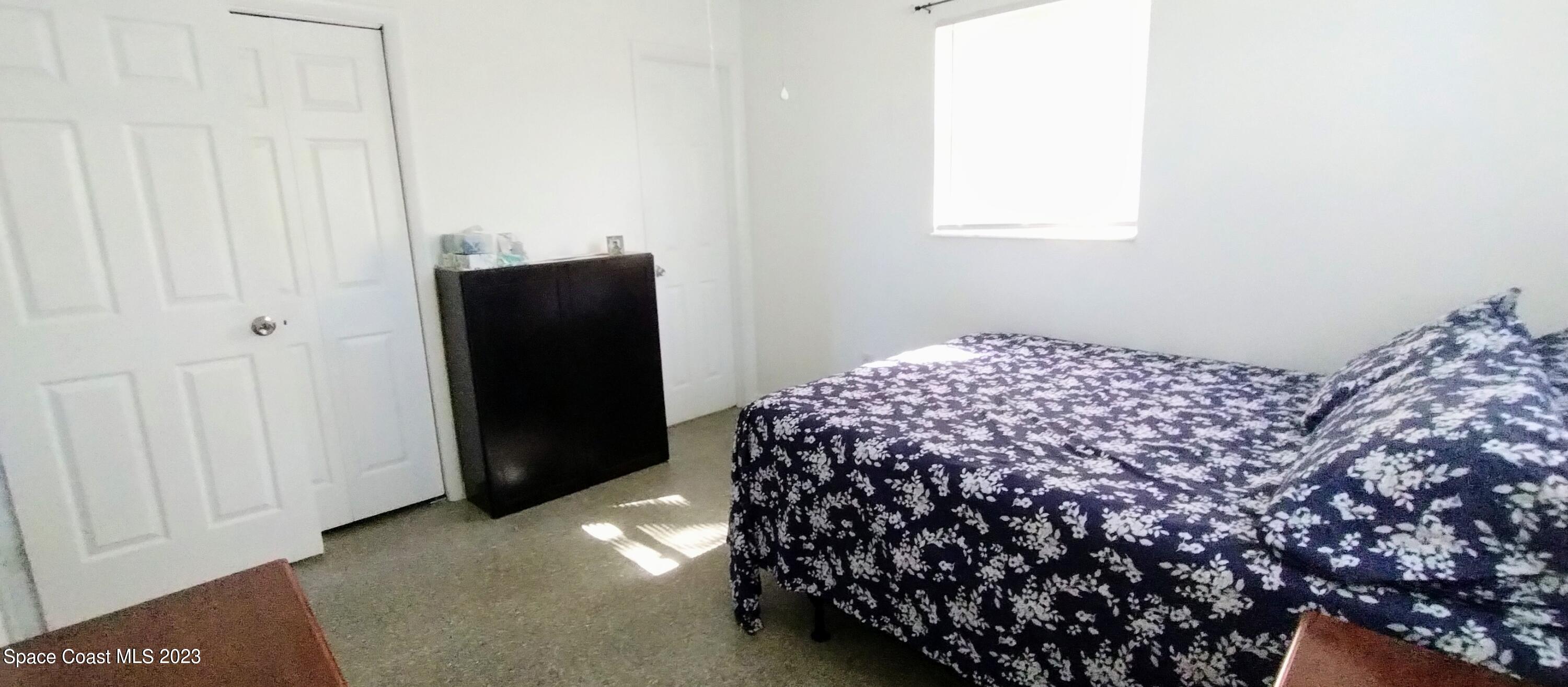 4100 Edwards Street Melbourne, FL 32901 - Photo 11 of 22 a bedroom with a bed and a window
