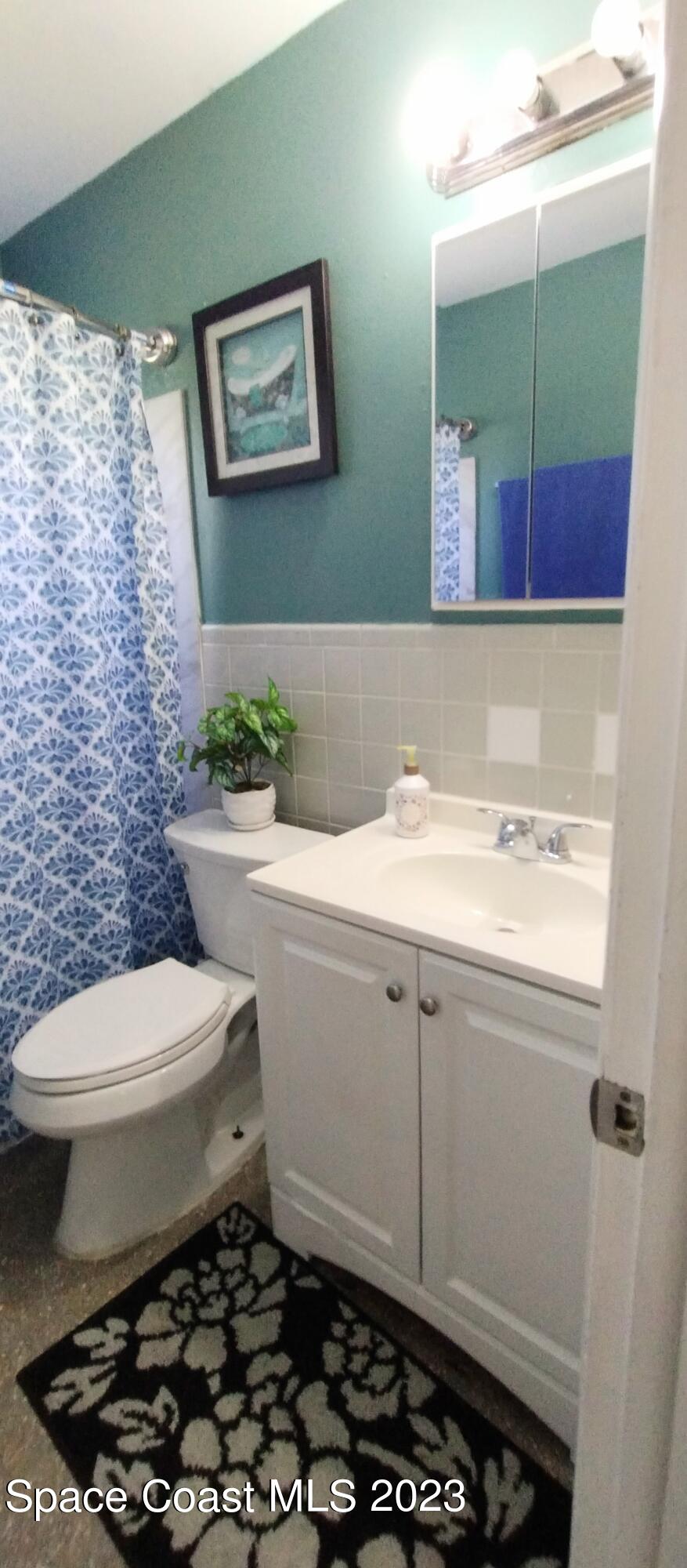 4100 Edwards Street Melbourne, FL 32901 - Photo 15 of 22 a bathroom with a toilet a sink and a mirror