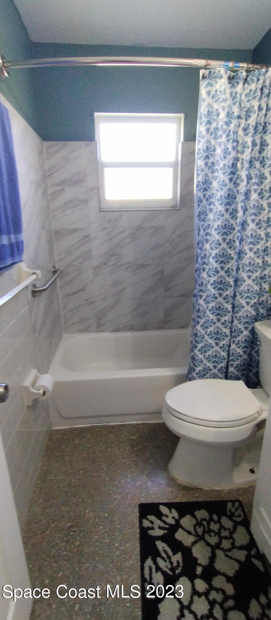 4100 Edwards Street Melbourne, FL 32901 - Photo 16 of 22 a bathroom with a toilet and a shower