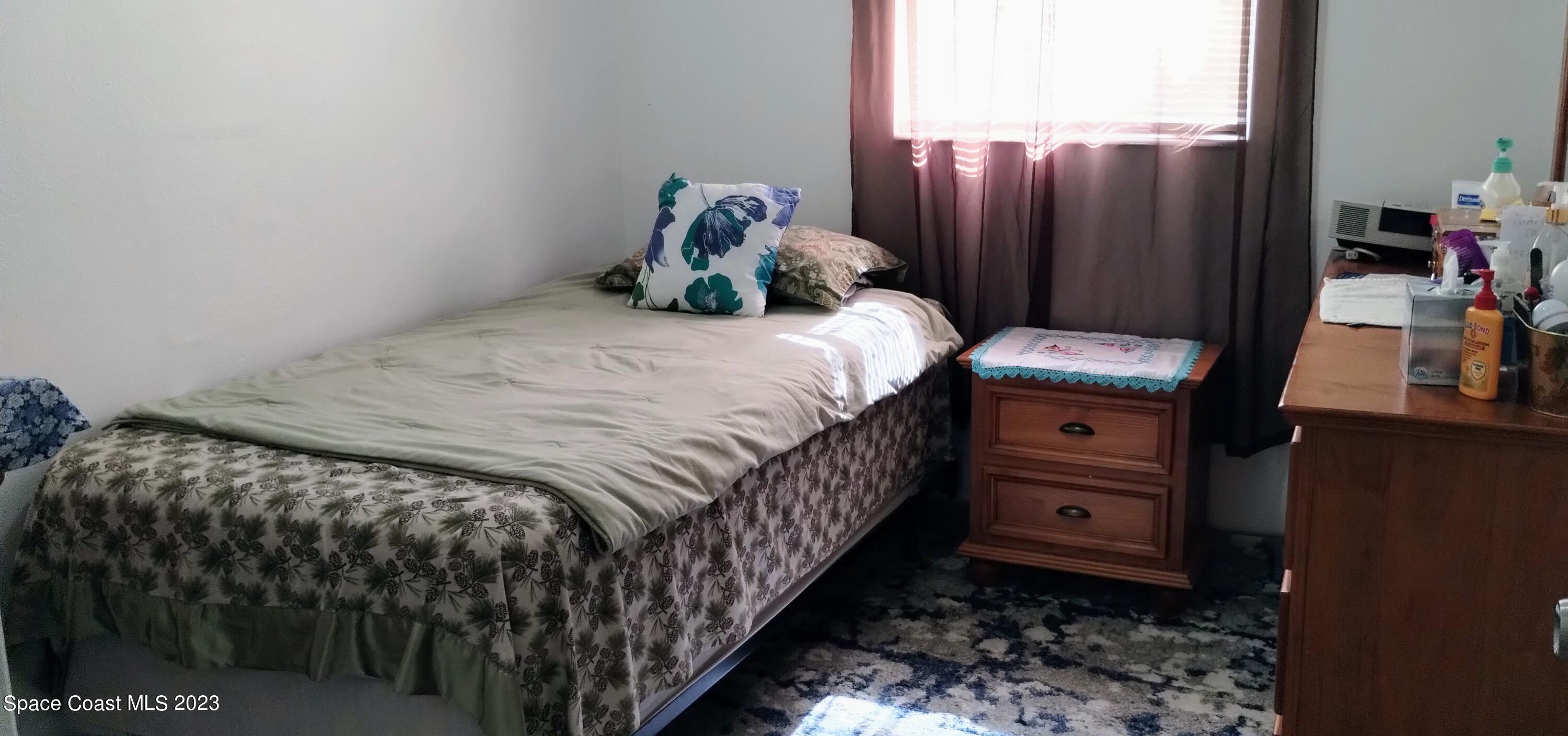 4100 Edwards Street Melbourne, FL 32901 - Photo 17 of 22 a bedroom with a bed and a closet