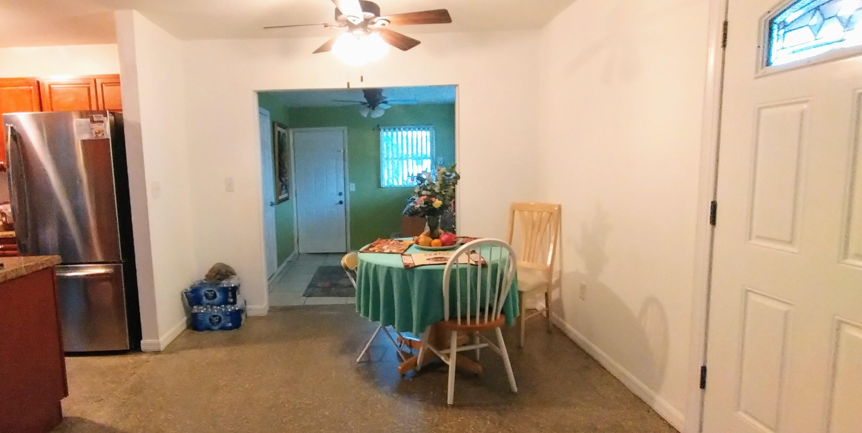 4100 Edwards Street Melbourne, FL 32901 - Photo 5 of 22 a dining room with furniture and a chandelier