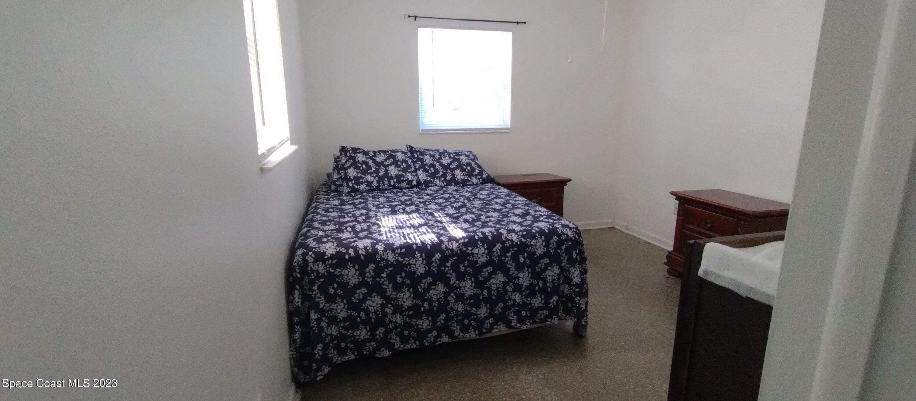 4100 Edwards Street Melbourne, FL 32901 - Photo 10 of 22 a bed sitting in a bedroom next to a window