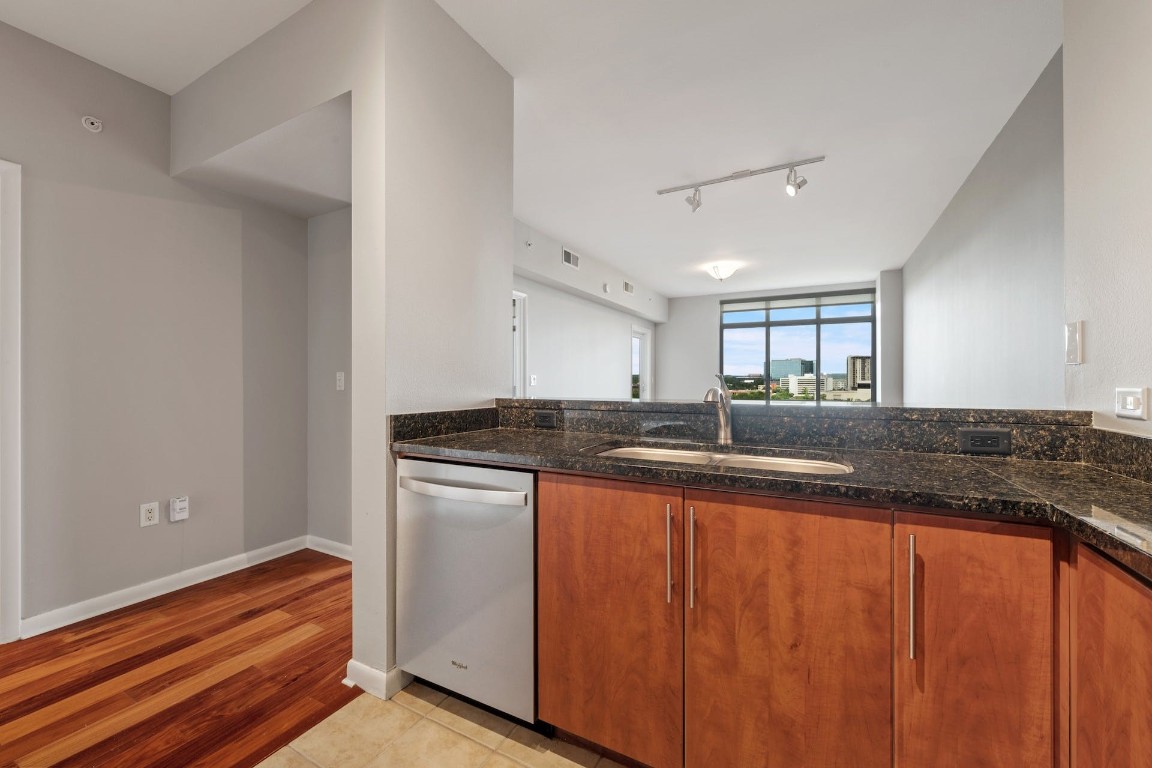 54 Rainey Street, Unit 810 Austin, TX 78701 - Photo 12 of 35 a kitchen with granite countertop stainless steel appliances counter space and a sink