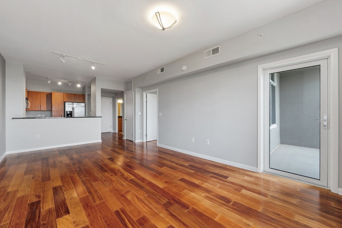 54 Rainey Street, Unit 810 Austin, TX 78701 - Photo 15 of 35 wooden floor in an empty room with a window