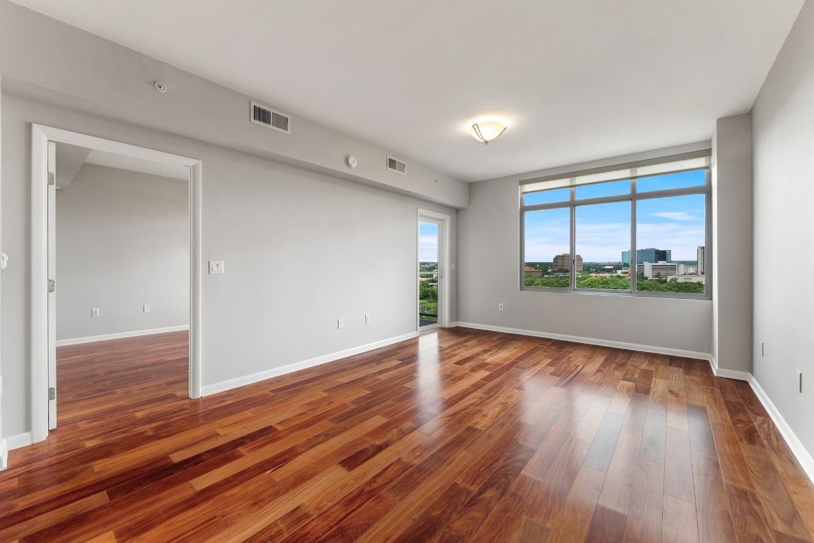 54 Rainey Street, Unit 810 Austin, TX 78701 - Photo 17 of 35 wooden floor in an empty room with a window