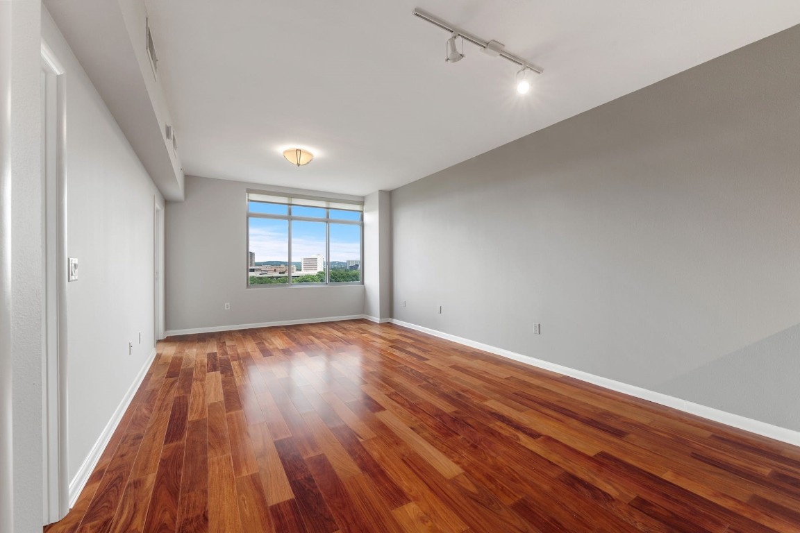 54 Rainey Street, Unit 810 Austin, TX 78701 - Photo 19 of 35 wooden floor in an empty room with a window