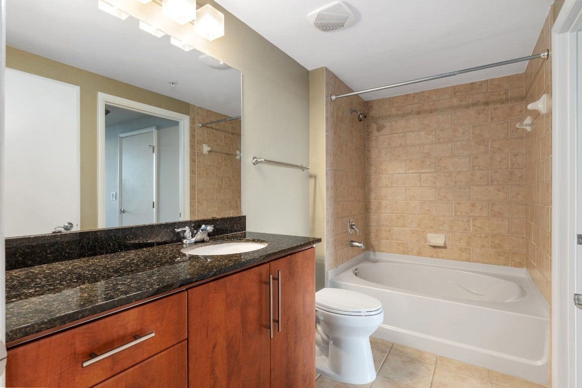 54 Rainey Street, Unit 810 Austin, TX 78701 - Photo 27 of 35 a bathroom with a granite countertop sink toilet and shower